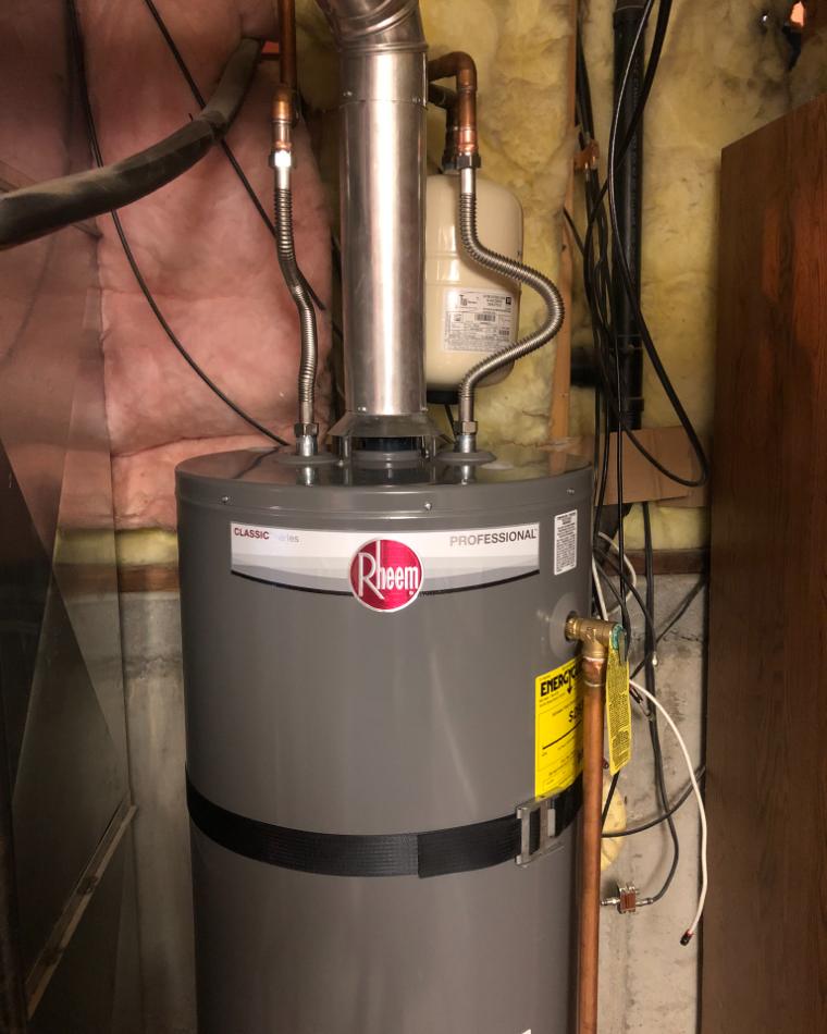 A new gas water heater installed by Lakeside in a basement utility room
