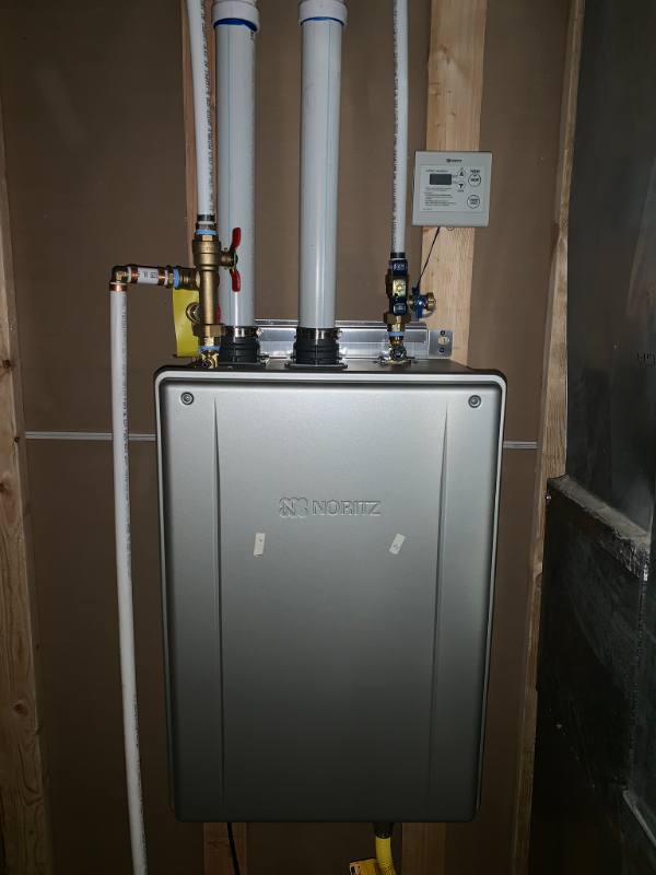 Wall-mounted tankless water heater with new venting and valves