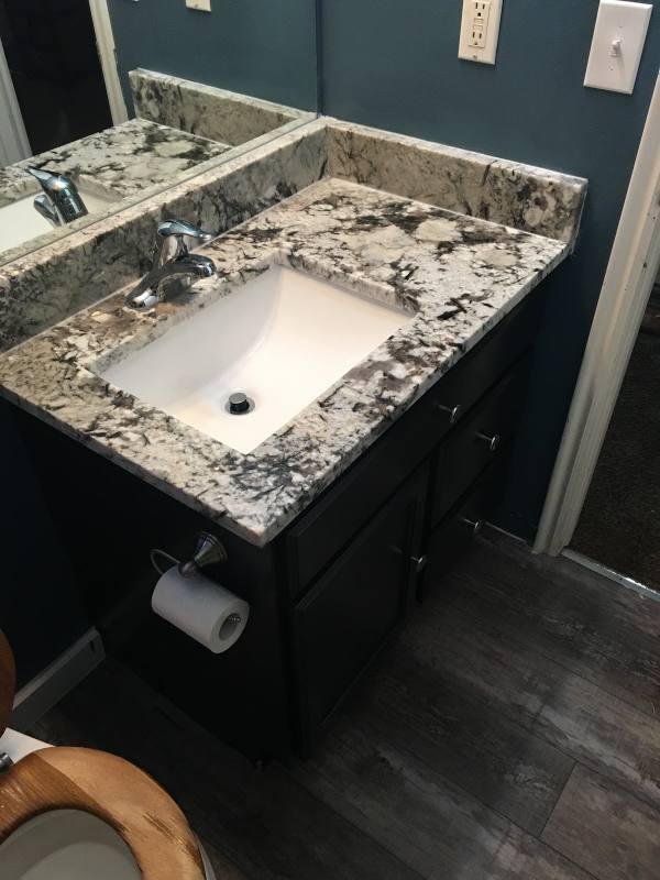 Granite vanity top with an undermount sink and chrome faucet